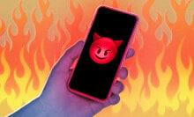 An illustration of an iPhone 15 in a field of flames with a devil emoji displaying on the screen.