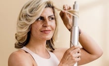 woman styling her hair with shark flexstyle autowrap curler