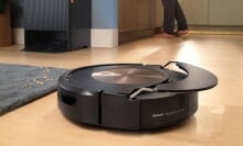 a roomba combo j9 robot vacuum and mop cleans a wood floor