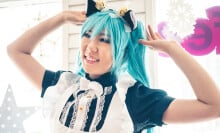A young woman wearing cat ears as part of a costume.