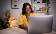Woman smiling at computer.