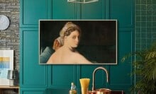 a samsung the frame TV sits on a turquoise wall in a kitchen with still frame art work displayed