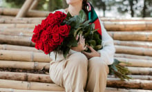 woman holding huge bouquet of roses