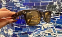 Ray-Ban Meta Smart Glasses in front of a wall with varying hues of blue