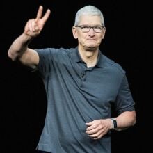 Tim Cook, Apple CEO, flashes a peace sign