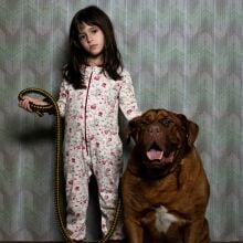A little girl in her jammies and hanging with her dog in "When Evil Lurks."