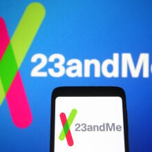 23andme logo on a background and on a phone