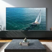 Samsung TV with ocean screensaver on TV stand in living room