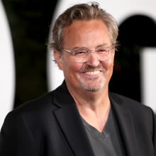 Matthew Perry smiling at the camera at the 2022 GQ Man of the Year red carpet.