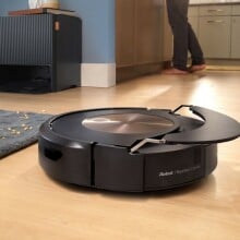 a roomba combo j9 robot vacuum and mop cleans a wood floor