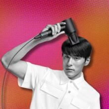 a man uses a dyson supersonic origin hair dryer