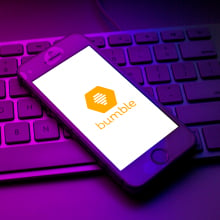 Bumble logo seen displayed on a smartphone on top of a computer keyboard