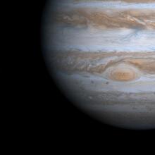 Jupiter orbited by its volcanic moon Io.