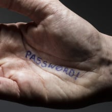 the word password written on the palm of a man's hand
