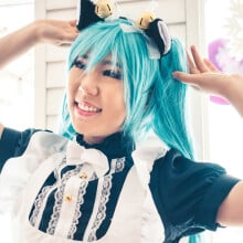 A young woman wearing cat ears as part of a costume.