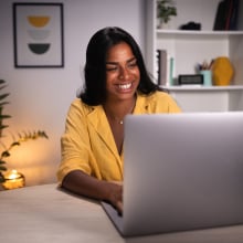 Woman smiling at computer.