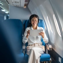 woman using tablet on a plane