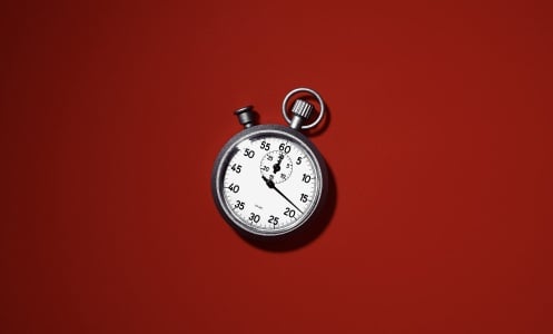 A timer sits against a red background.