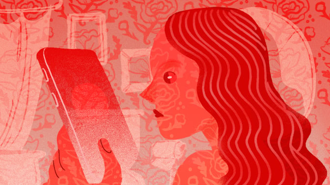 woman looking at her phone; entire image is red-tinted