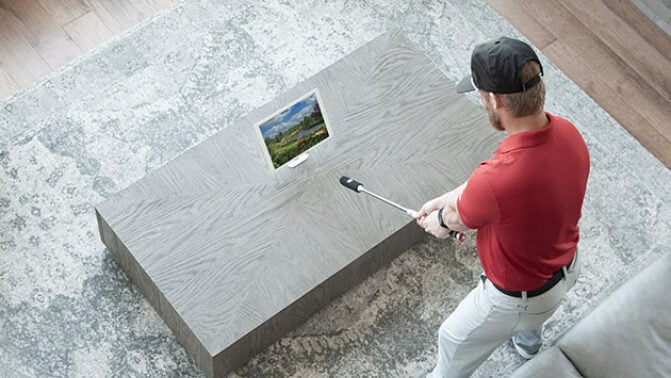 man using simulated golf stick
