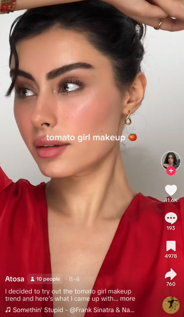 A TikToker trying on 'tomato girl' makeup.