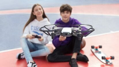 Kids playing with a kid-friendly drone from Tello.