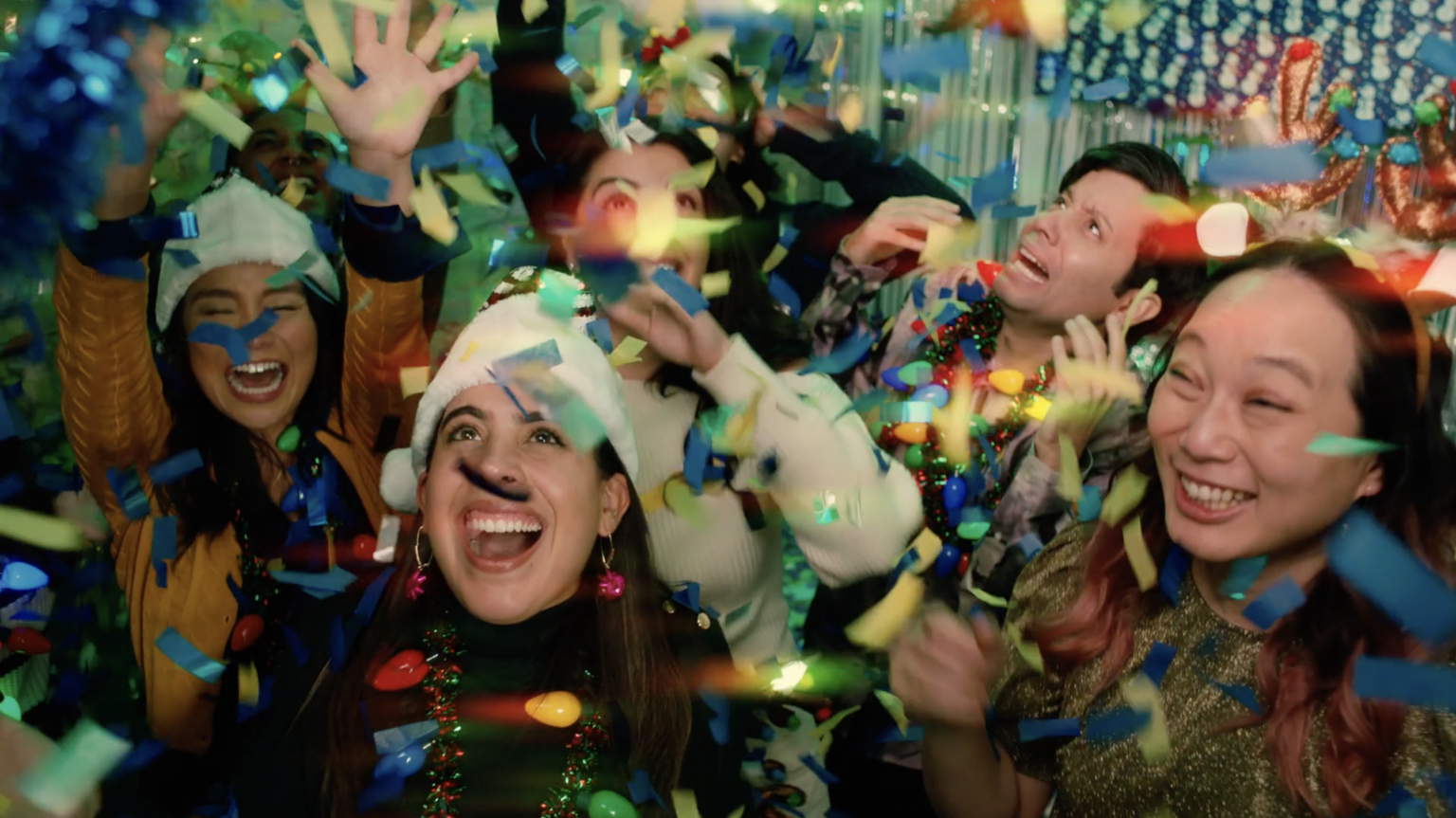 Office party-goers dancing with confetti and holiday decor