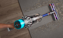 a close-up, top-down view of someone vacuuming a carpet with a Dyson Gen5outsize