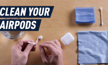 hands cleaning airpods with cotton swab