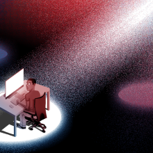 A spotlight highlighting a person on a computer.