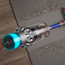 a close-up, top-down view of someone vacuuming a carpet with a Dyson Gen5outsize