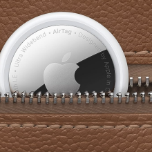 close-up of Apple AirTag tucked into leather luggage