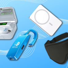 headphones, nintendo docking station, wireless charger, and sleep mask with blue background