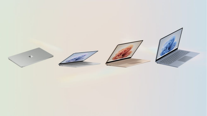 four microsoft surface laptop go 3s against a rainbow pastel background
