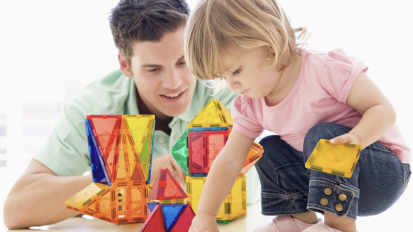 man and little girl playing with magnetic tiles